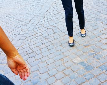 Low section of person standing on footpath