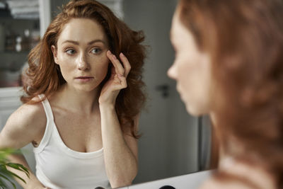 Side view of young woman looking away