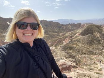 Portrait of a smiling young woman in a desert canyon