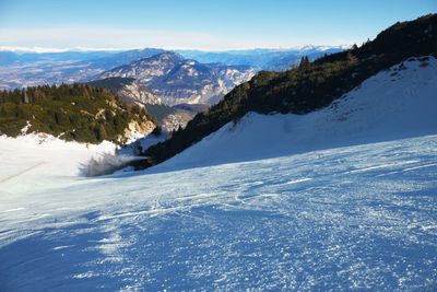 Snowmaking on slope. skier near a snow cannon making snow. mountain ski resort and winter season