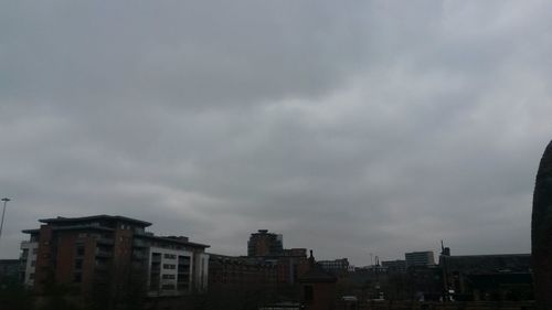 Low angle view of buildings against cloudy sky