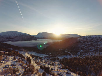 Aerial view of snowcapped mountains against sky