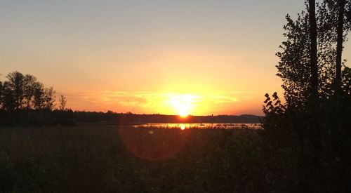 Scenic view of field against sky during sunset