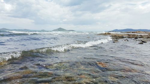 Scenic view of sea against cloudy sky