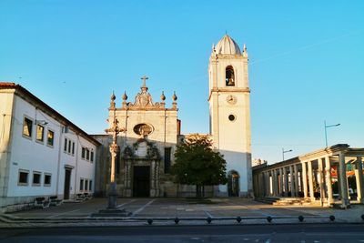 View of cathedral and buildings against clear blue sky