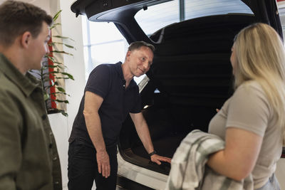 Customers in car dealership office