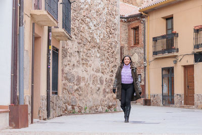 Portrait of woman walking on street