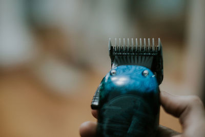 Close-up of hand holding hair trimmer