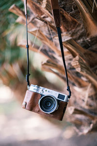 Close-up of a vintage fujifilm camera in a tropical location, an iconic symbol of travel photography