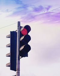 Low angle view of road signal against sky