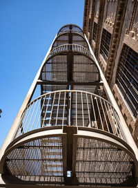 Low angle view of skyscraper against clear blue sky