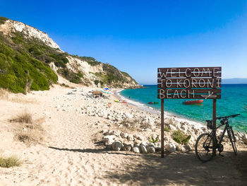 Scenic view of beach against clear blue sky