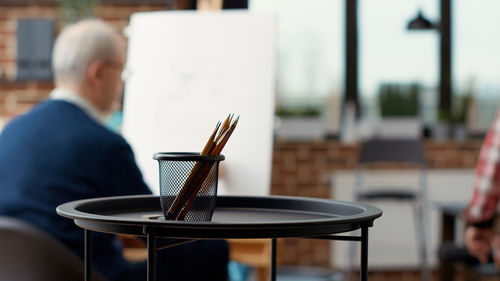 Pencils in container on table