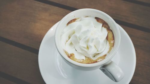 High angle view of cappuccino served on table