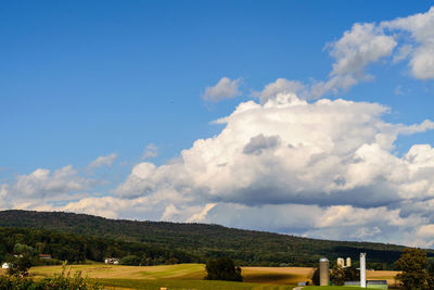 Scenic view of landscape and houses against sky