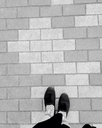 Low section of woman standing on tiled floor