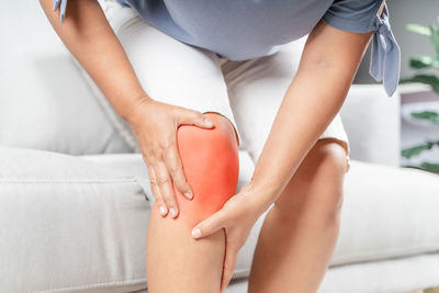 Midsection of woman sitting on floor