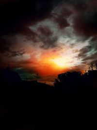 Silhouette of landscape against cloudy sky