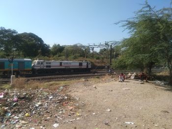 Abandoned train on land against clear sky