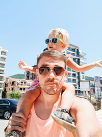 Portrait of man wearing sunglasses against clear sky