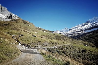 Scenic view of mountains against clear blue sky