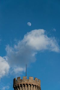 Moon and clouds over tower castle