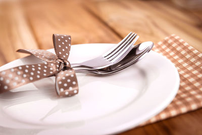 High angle view of eating utensils on wooden table