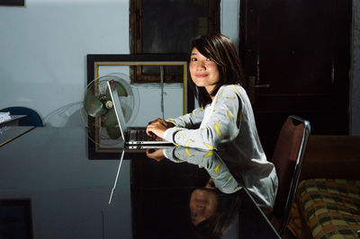 Woman sitting on table