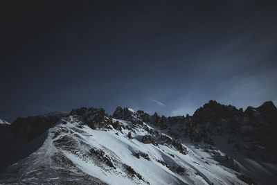 Scenic view of snow mountains against sky at night