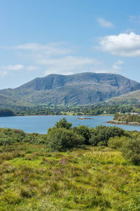 Scenic view of lake and mountains against sky