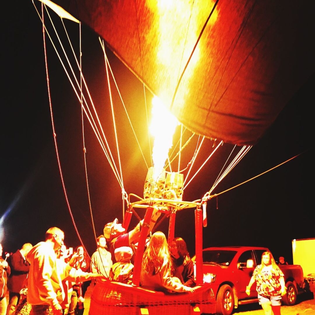 LOW ANGLE VIEW OF ILLUMINATED FIRE AT NIGHT