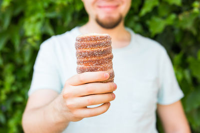 Midsection of man holding ice cream