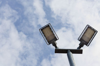 Low angle view of street light against cloudy sky