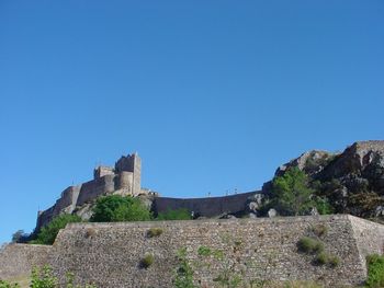 Low angle view of historic building against blue sky