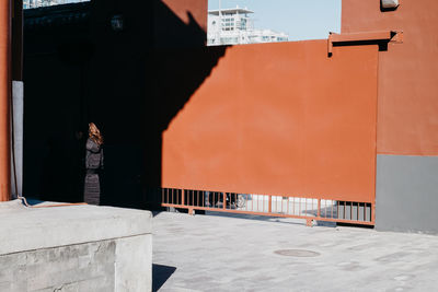 Man standing by building in city