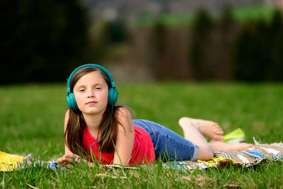 Portrait of beautiful young woman on field