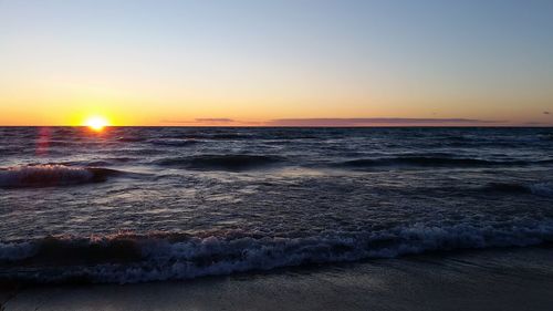 Scenic view of lake huron against clear sky during sunset
