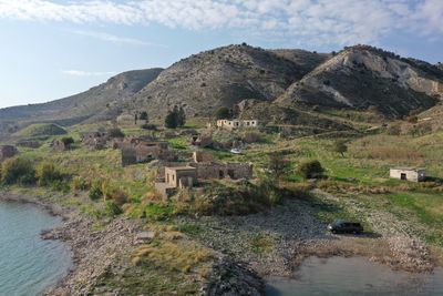 Scenic view of castle by mountain against sky