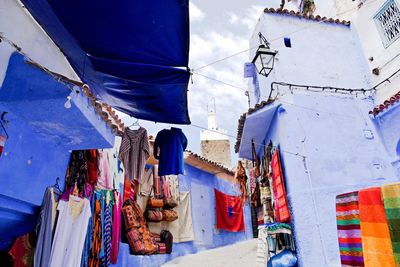 Low angle view of market stall amidst buildings