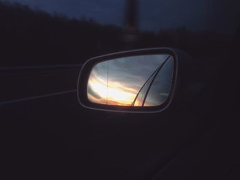 Reflection of sky in side-view mirror