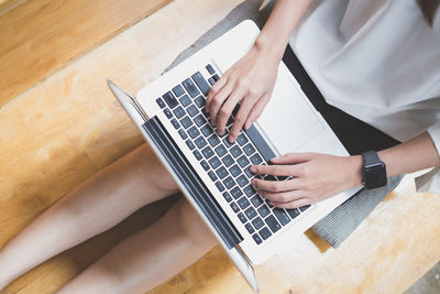 High angle view of man using laptop on table
