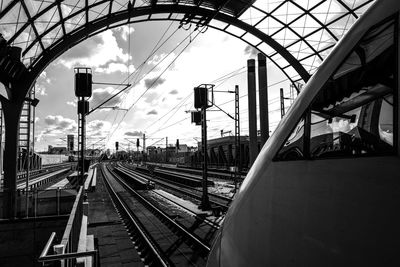 Train in railroad station against sky