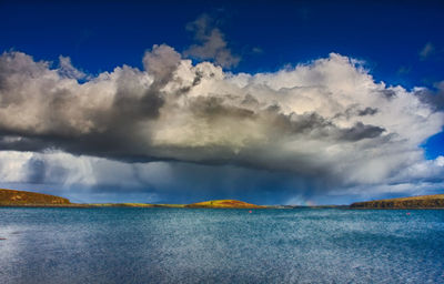 Panoramic view of sea against blue sky