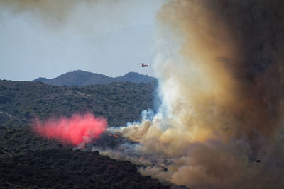 Airplane flying over forest fire