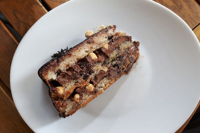 High angle view of cake in plate on wooden table