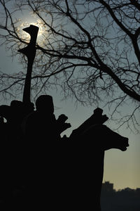 Low angle view of silhouette bare trees against sky at sunset