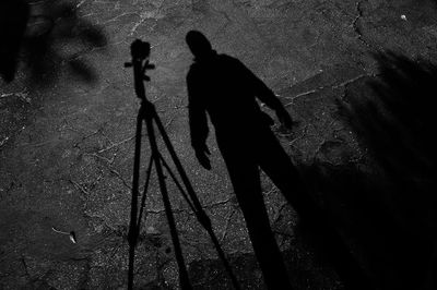 High angle view of men shadow on footpath