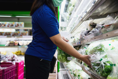 Midsection of woman standing at market stall