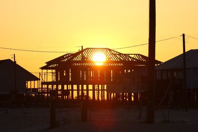 Silhouette buildings against sky during sunset