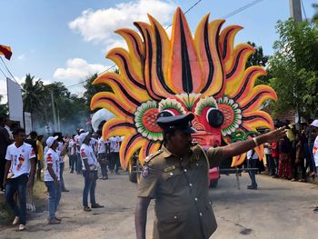 People dancing on street against sky
